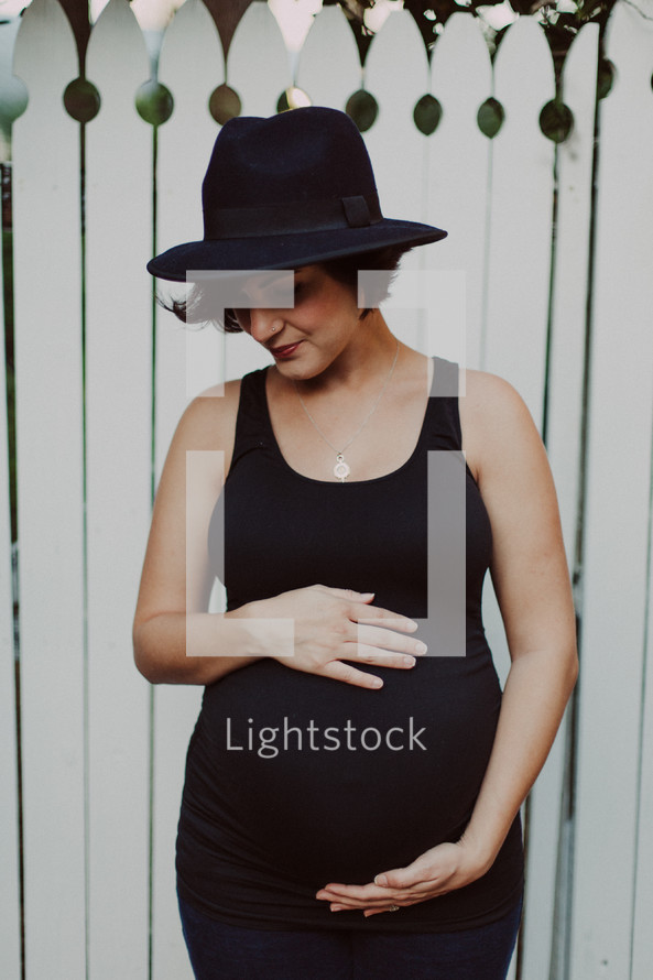 pregnant woman in a black hat 