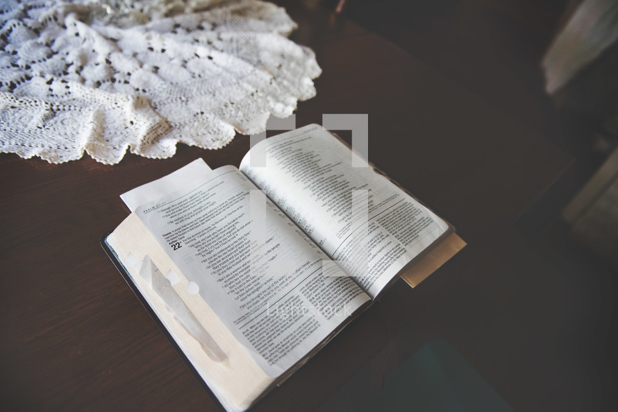 open Bible and lace cloth on a table 