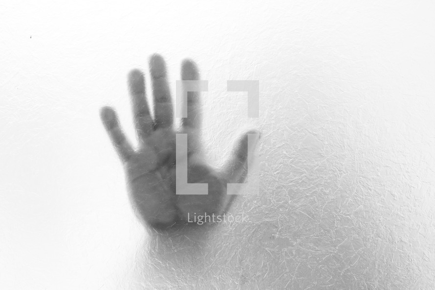 hand through frosted glass