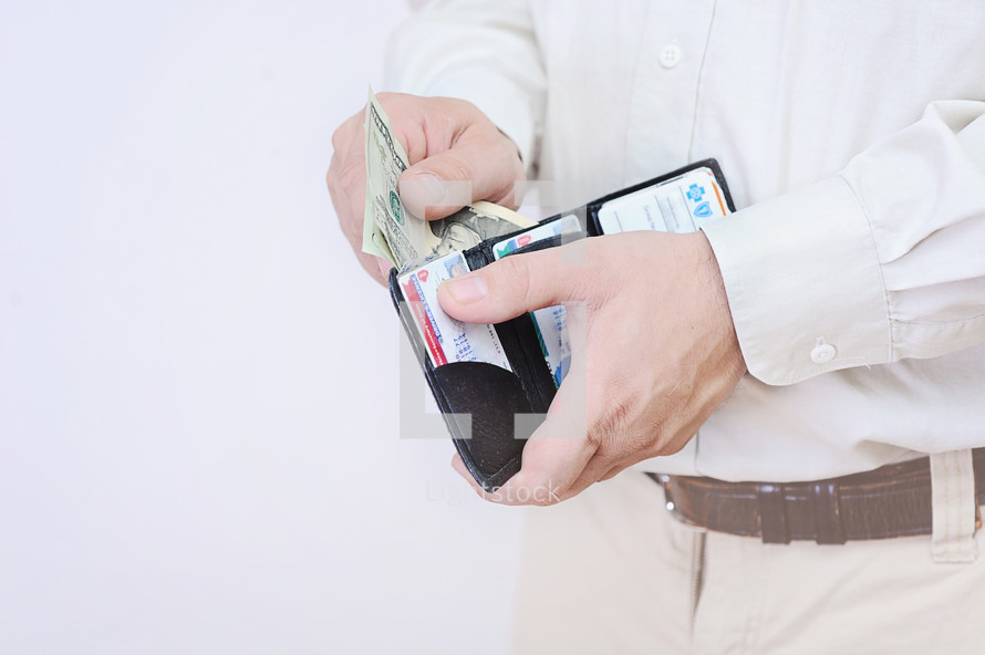 man pulling out cash from his wallet 