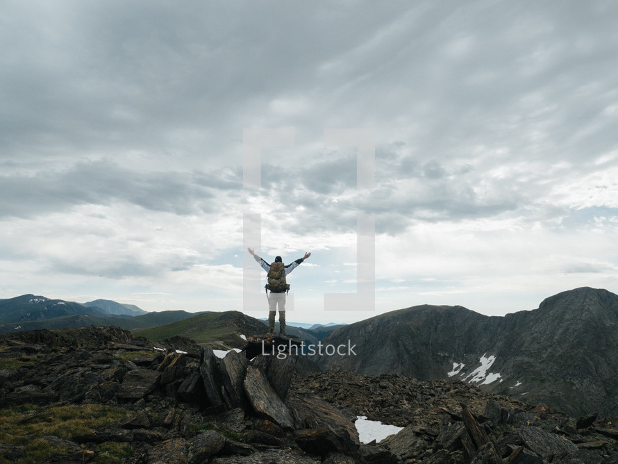 man standing on a rocky mountaintop 
