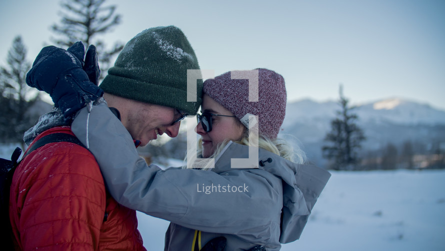 a couple hugging outdoors in winter 