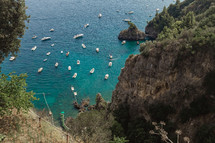boats on the water by a shoreline in Italy 