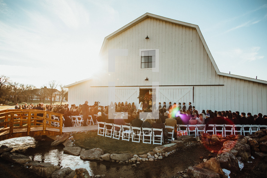 outdoor wedding ceremony by an old barn 
