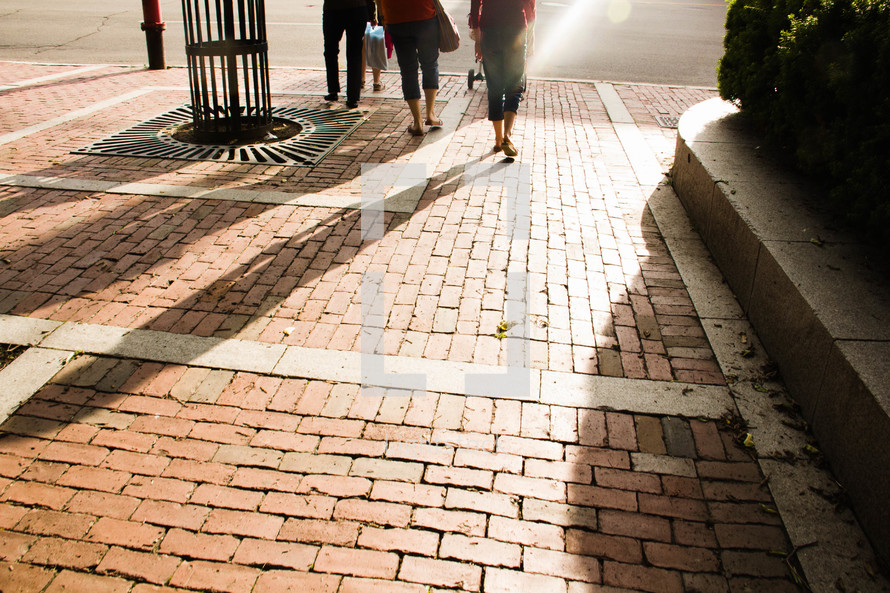 sunlight shining on a brick sidewalk 