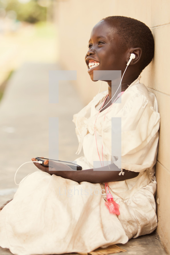 joyful child listening to music on an iPod