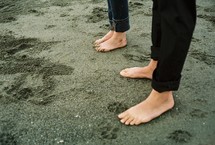 Barefoot couple in sand