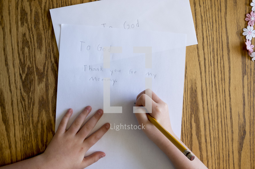 A child writing a thank you note to God 