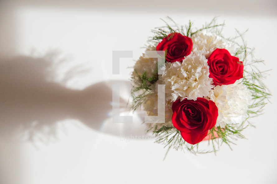 carnations and roses in a vase 
