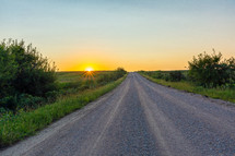 rural gravel road at sunset 