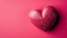 Red heart on a pink background. Valentine's day background with copy space.