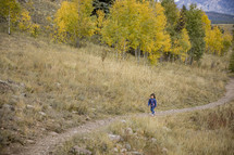 child walking on a mountain trail 
