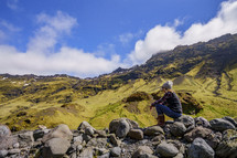 a woman sitting on a rock in Iceland 