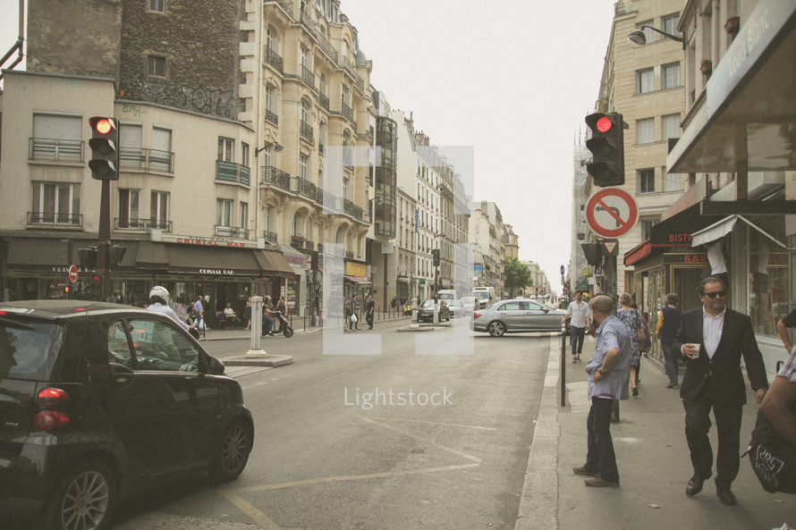 people walking on a city sidewalk in Paris 