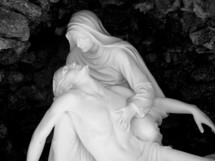 Mary and Jesus  statue called The Pietà (meaning "pity", "compassion") is a subject in Christian art depicting the Blessed Virgin Mary cradling the mortal body of Jesus Christ after his Descent from the Cross. It is most often found in sculpture.