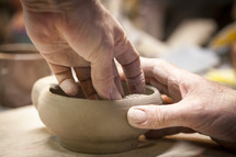 shaping clay with hands 