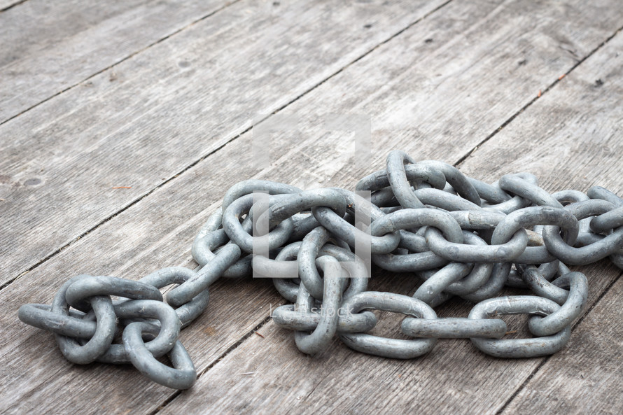 chain links on a wood background 