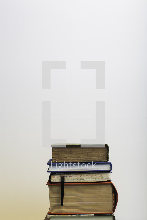 stack of books against a white background 