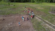 Drone footage circling people in a field in Honduras