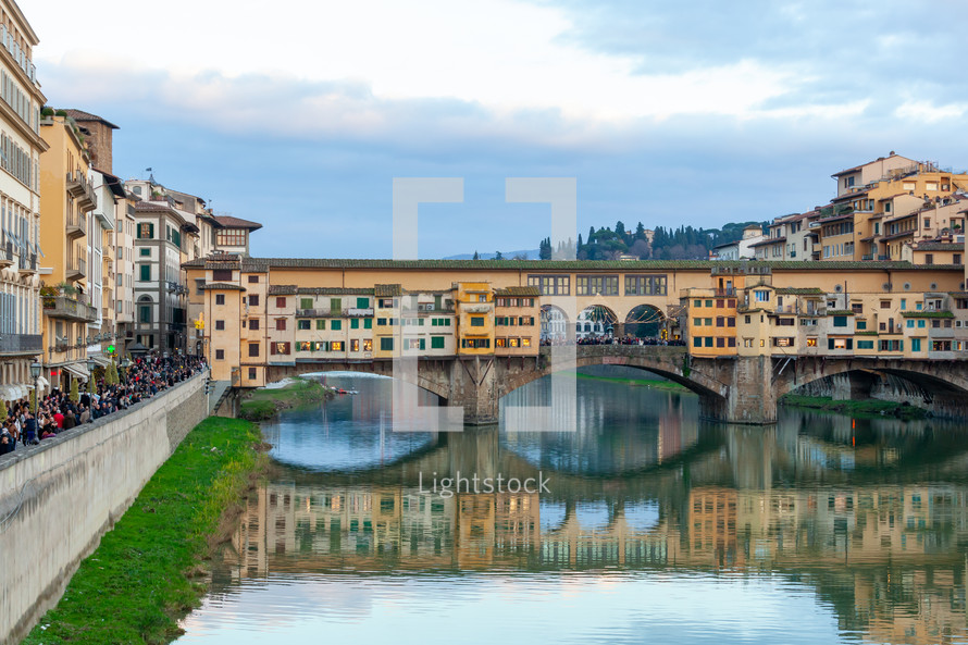 View of medieval stone bridge Ponte Vecchio and the Arno River from the Ponte Santa Trinita  in Florence, Tuscany, Italy.