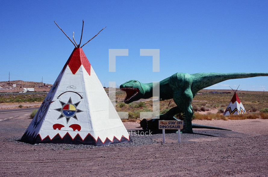 tepee and dinosaur statue 