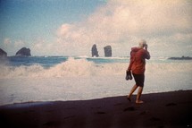 Film photograph of a woman walking along the beach