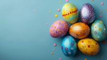 Colorful easter eggs on blue background with copy space for text.