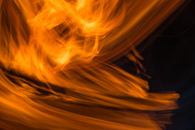 Swirling orange flames on a black background.