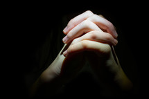 praying hands with interlaced fingers 