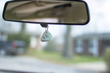 I pick you guitar pic hanging on a car mirror 