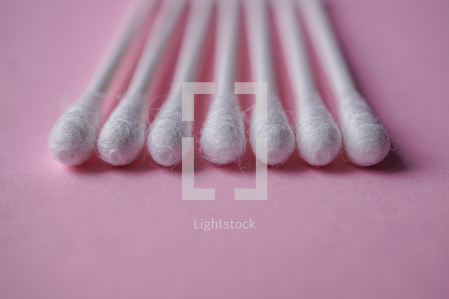 cotton swabs on the pink background, cosmetic  and hygiene