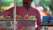 Man selling fruit at the Dakshineswar Kali Hindu Temple in Kolkata, India.