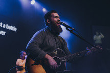 man singing during worship service 