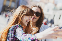 Two young adults take a selfie in Piazza del Plebiscito in Naples.