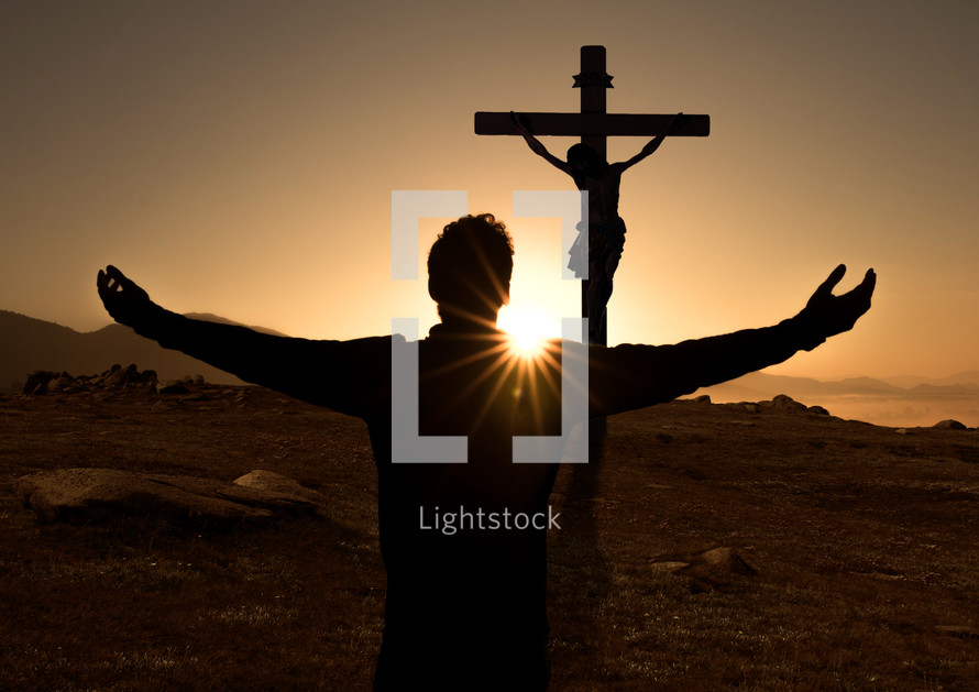 outstretched arms in front of Jesus on the cross 