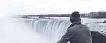 a man looking out over the Niagara Falls 