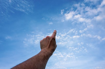 hand up in the air, blue sky background