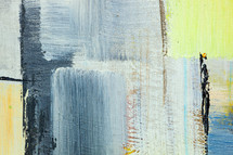 Abstract detail of acrylic paints on canvas. Relief artistic background in blue, yellow and  silver color.
