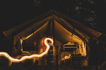 streak of light and bunks in a tent 