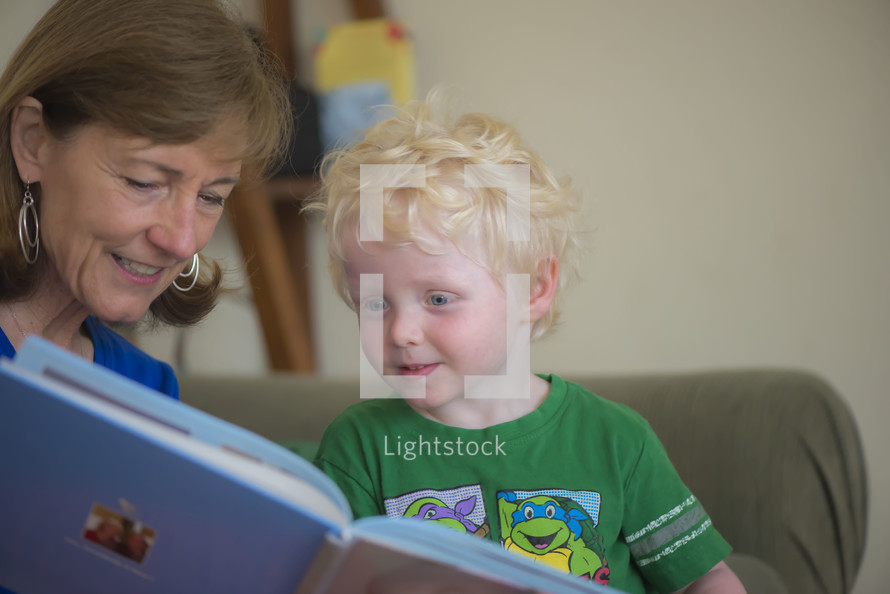 A grandmother reading to her grandson 