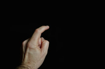 index finger pointing at a digital screen