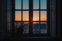 Old looking windows with the sun rising in the foreground