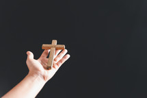 Wooden cross and hand