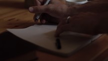a man writing in a journal 