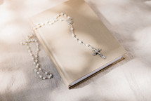 rosary on a Bible 
