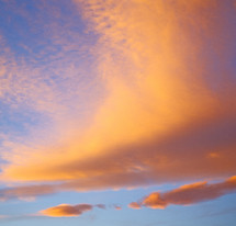 pink and yellow clouds in a blue sky 