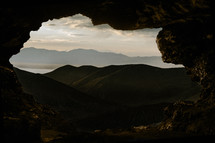 view of mountains from a cave 