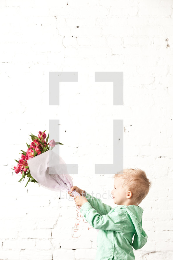 boy holding a bouquet of flowers
