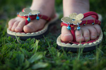 feet of a girl child wearing flip flops