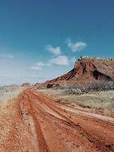 red dirt road and red rock peaks 